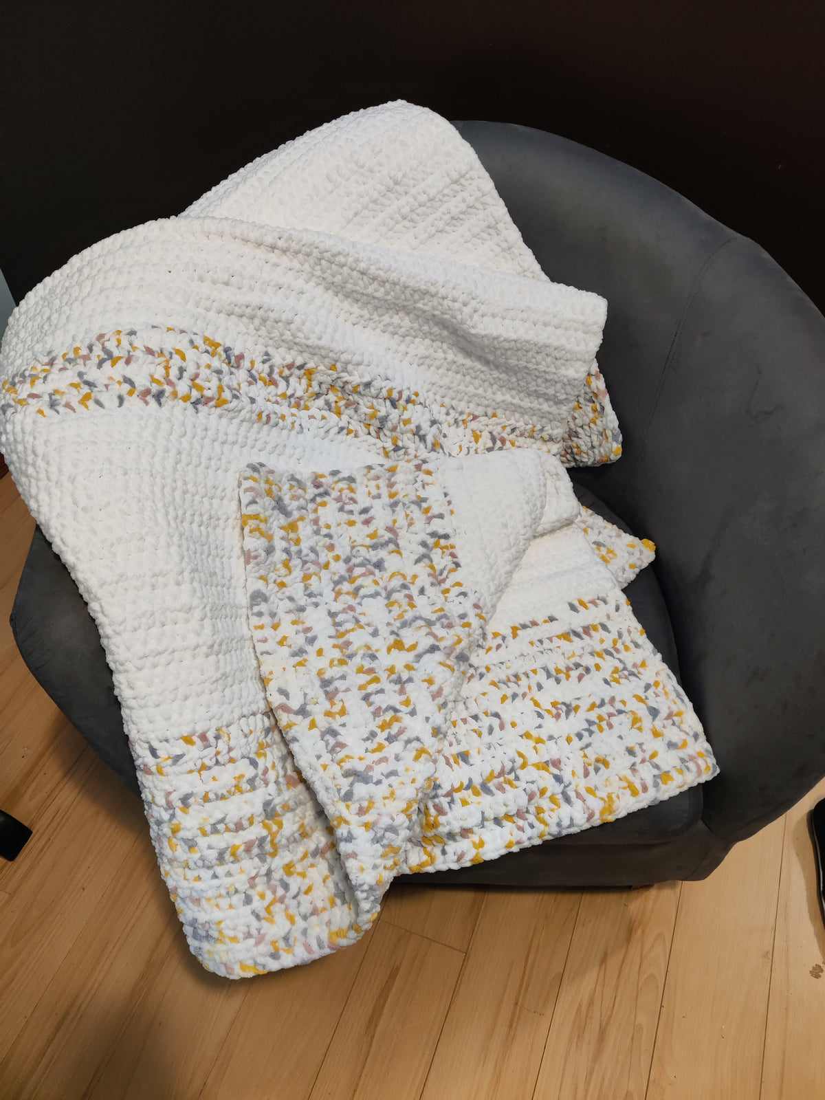 White, pink, yellow, gray, crochet blanket 