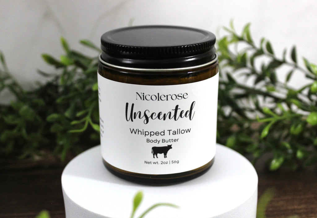 Nicolerose Unscented Whipped Tallow Body Butter jar on a white pedestal with greenery in the background
