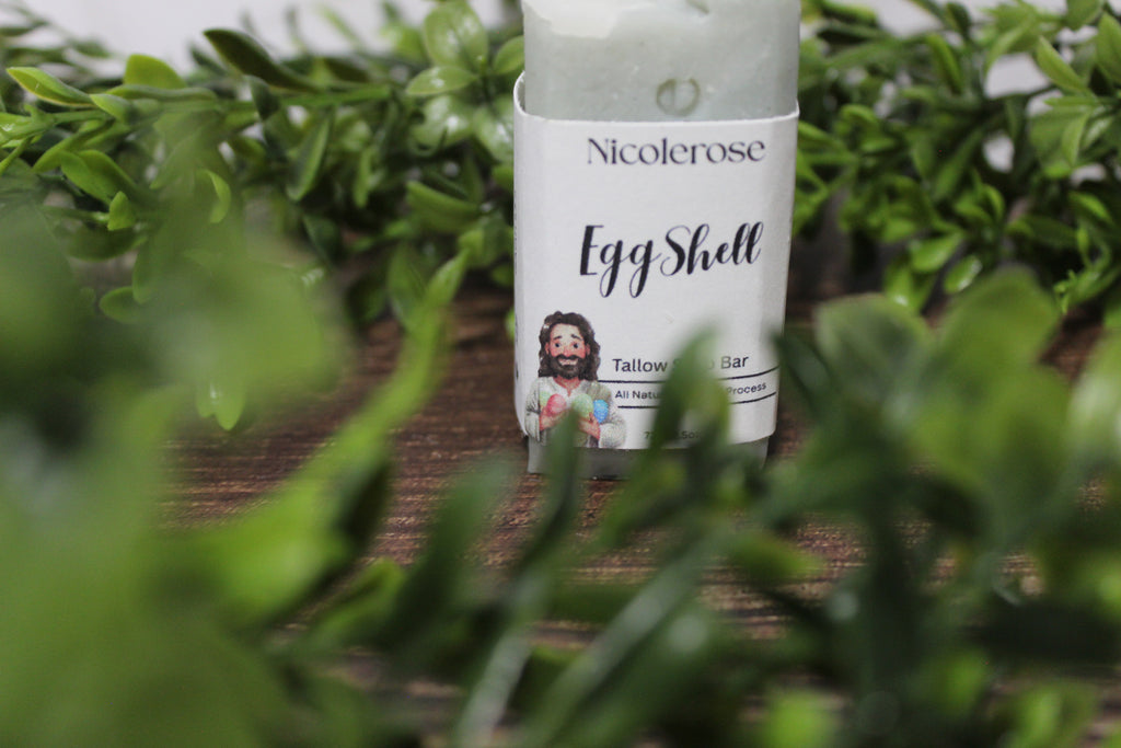 Nicolerosse Egg Shell product on a wooden surface with greenery in the background