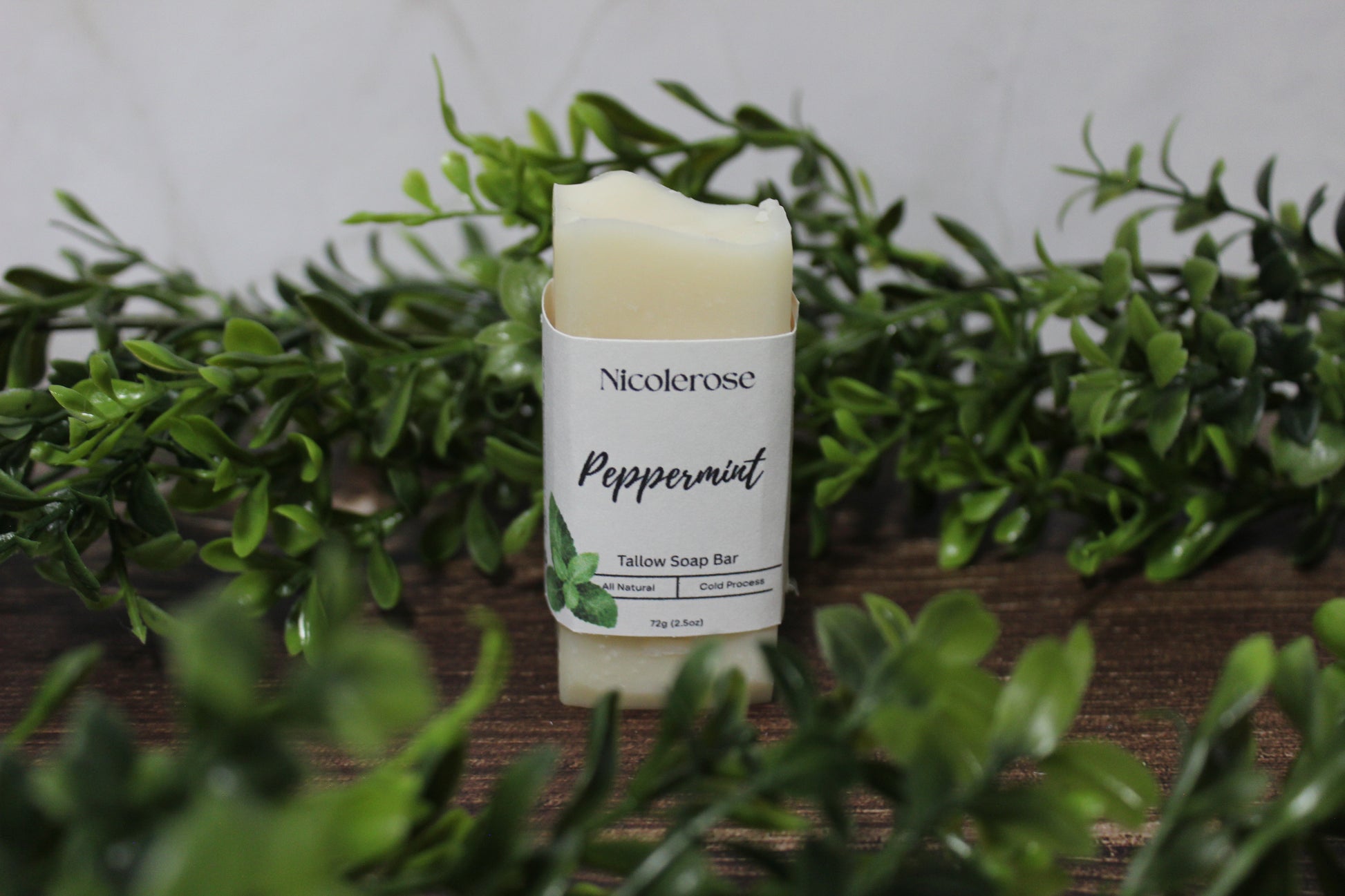 Nicolerose peppermint tallow soap bar with greenery in the background
