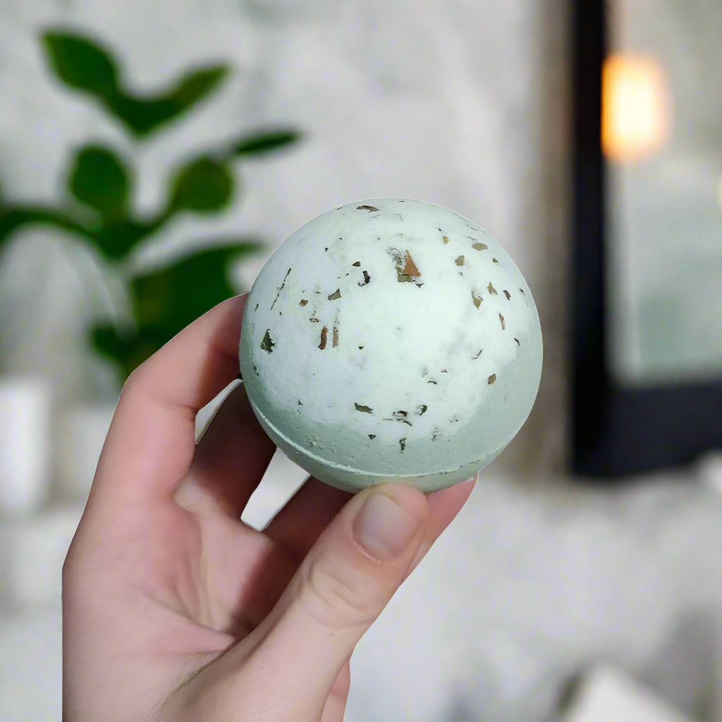 Peppermint scented bathbomb, white and green with dried peppermint leaves 